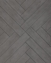 Close-up of wooden bench top showing a parquet-like herringbone pattern with diagonal slats.