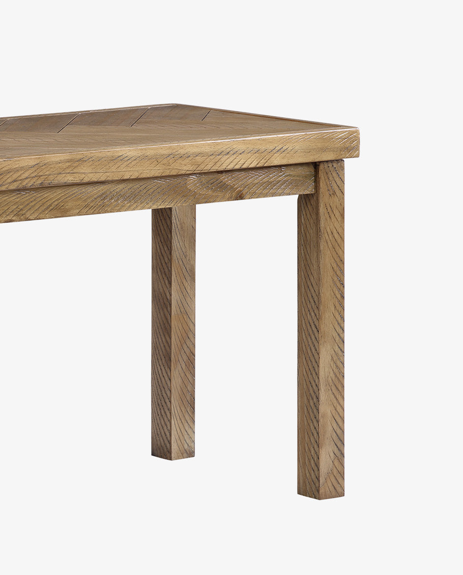 Detail of bench corner and edge showing joined frame and wood grain.