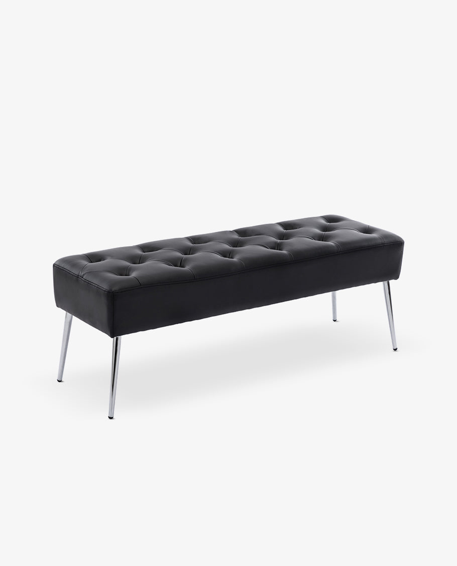 Close-up of white tufted upholstery showing deep buttoned tufting and soft cushioning.