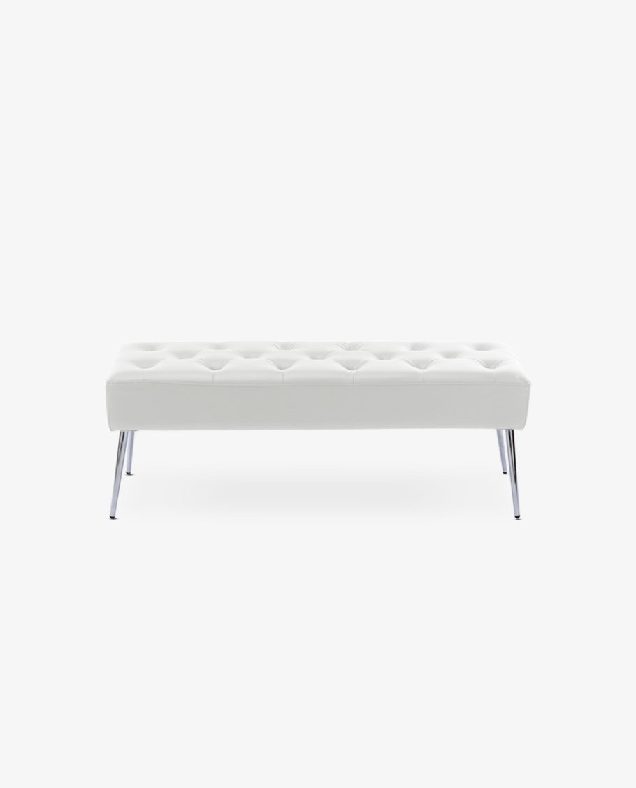 Rear view of white tufted bench with metal legs on rug, empty background.